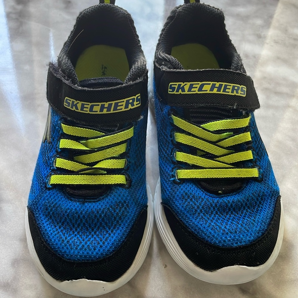 Two pairs of boys Skechers. One is size 12. Other is size 12.5